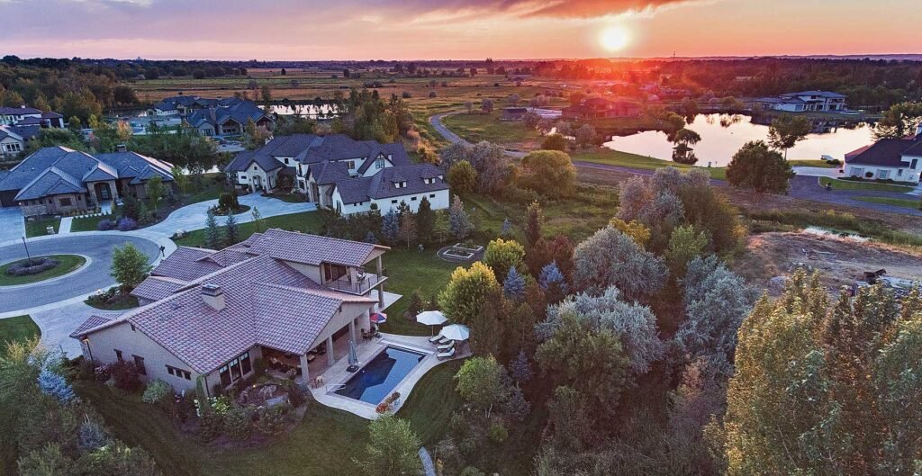 Aerial view of a home and the valley at sunset